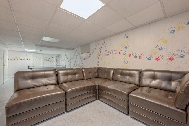 living area featuring a drop ceiling