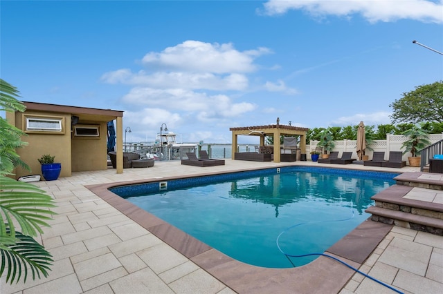 outdoor pool with fence, a pergola, and a patio