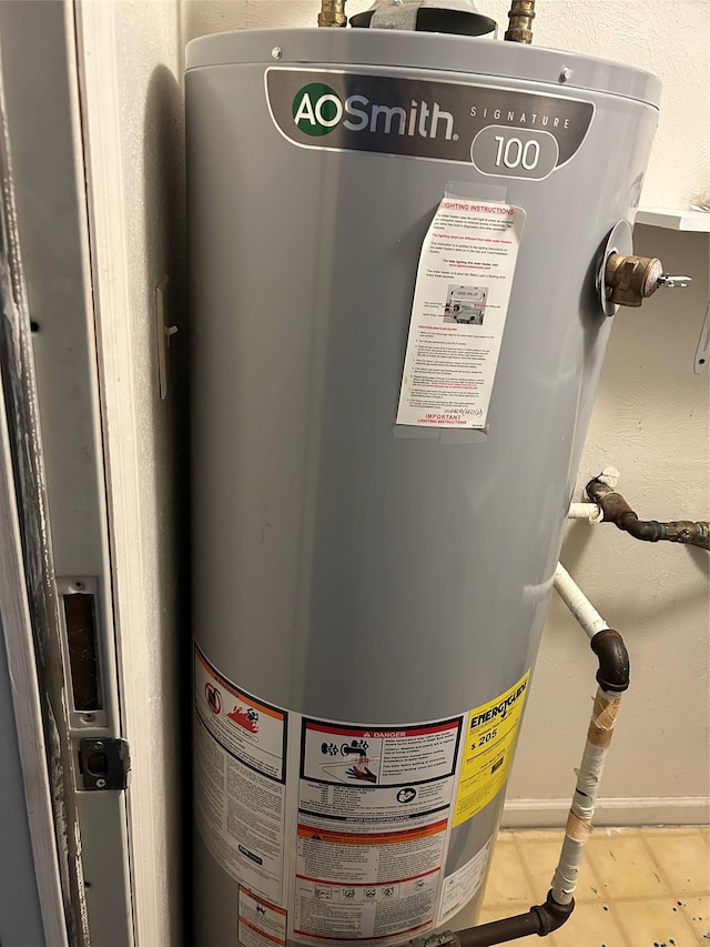 utility room featuring water heater