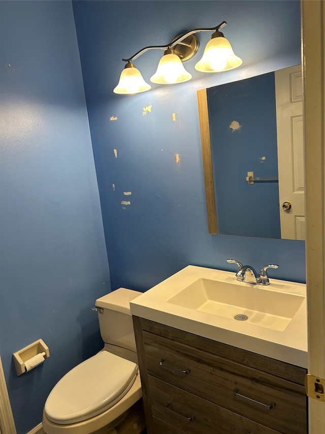 half bath featuring toilet and vanity