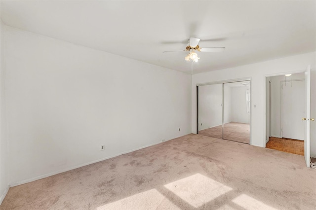 unfurnished bedroom featuring a closet, carpet flooring, and a ceiling fan