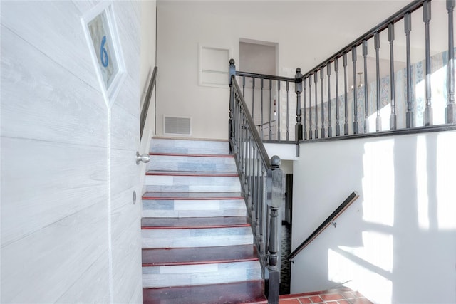 stairway with brick floor and visible vents