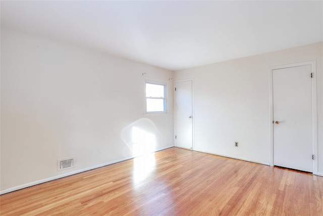 unfurnished room with visible vents and light wood-style flooring