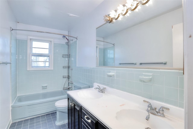 bathroom featuring shower / washtub combination, a sink, tile walls, and tile patterned floors