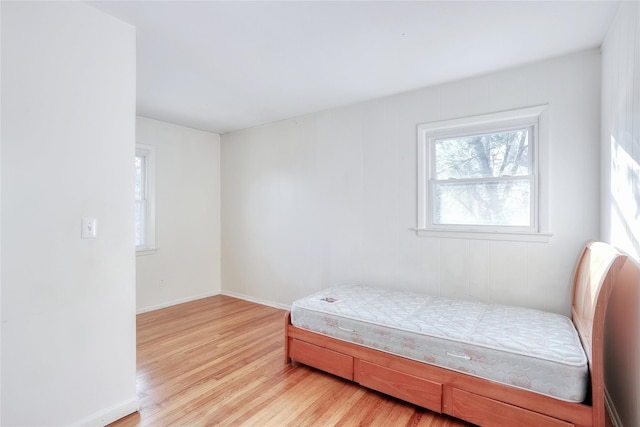 bedroom featuring light wood-type flooring and baseboards