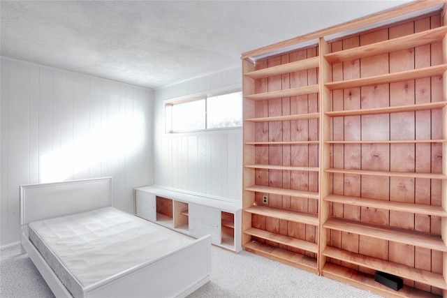 unfurnished bedroom with light carpet and a textured ceiling