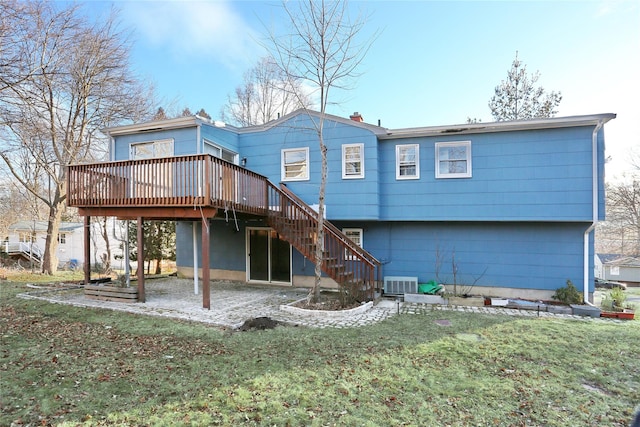 rear view of property featuring a wooden deck, a patio, stairway, a yard, and central air condition unit