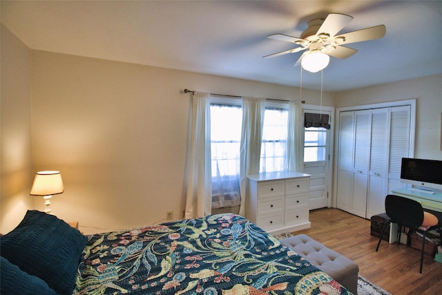 bedroom with a ceiling fan and light wood-type flooring