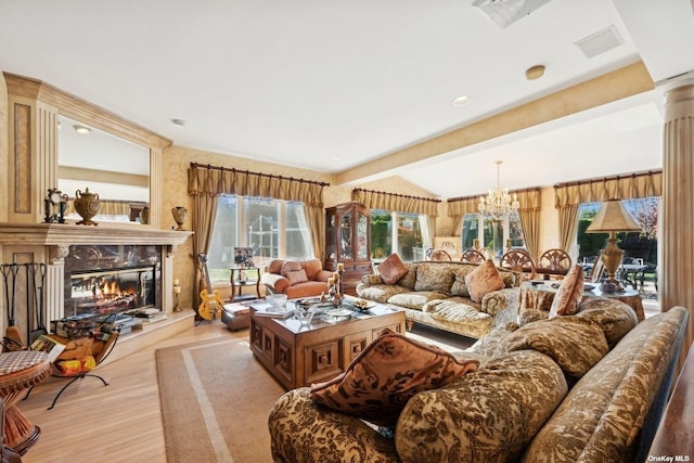 living area featuring decorative columns, visible vents, a high end fireplace, a chandelier, and light wood-type flooring