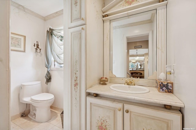 bathroom with baseboards, toilet, tile patterned flooring, crown molding, and vanity