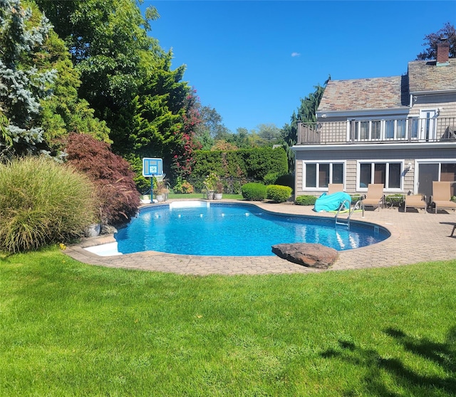 pool featuring a yard and a patio