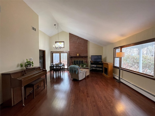 living area featuring visible vents, dark wood-type flooring, baseboard heating, a notable chandelier, and high vaulted ceiling