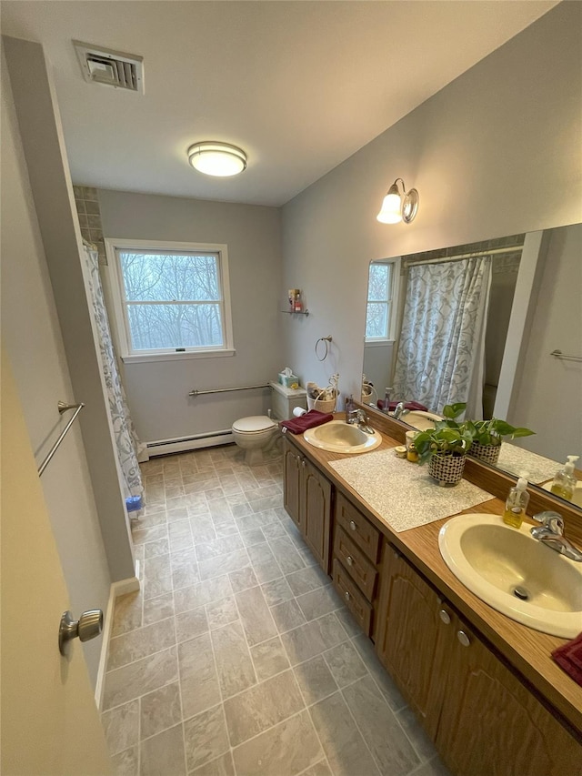 full bath with a sink, visible vents, baseboard heating, and toilet