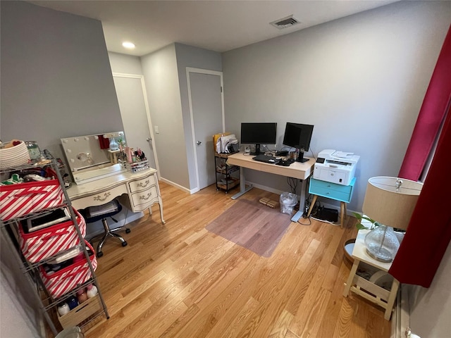 office with visible vents, baseboards, and wood finished floors