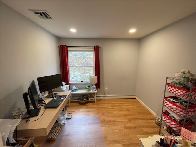 home office with visible vents, a baseboard heating unit, baseboards, light wood-type flooring, and recessed lighting