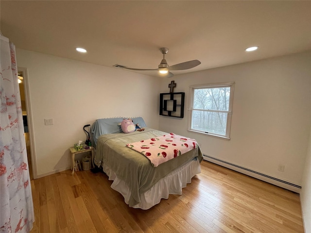 bedroom featuring visible vents, recessed lighting, light wood-style floors, and a baseboard radiator