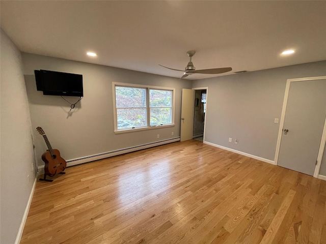 unfurnished bedroom featuring a baseboard radiator, baseboards, and light wood-style flooring