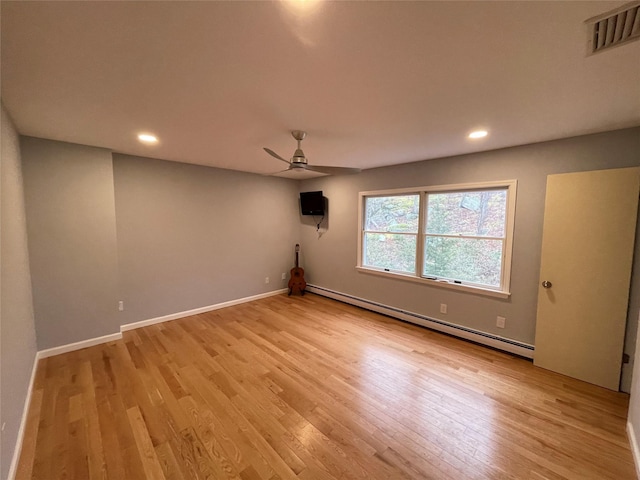 empty room featuring visible vents, a baseboard heating unit, recessed lighting, light wood-style flooring, and a ceiling fan