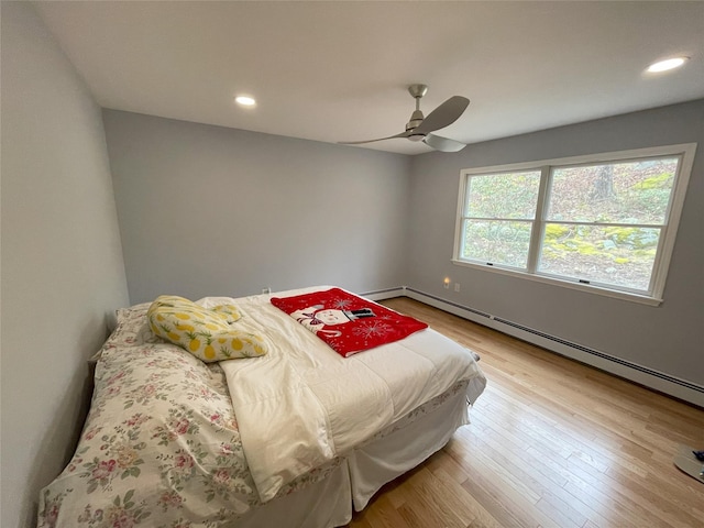 bedroom with ceiling fan, recessed lighting, light wood-type flooring, and a baseboard radiator