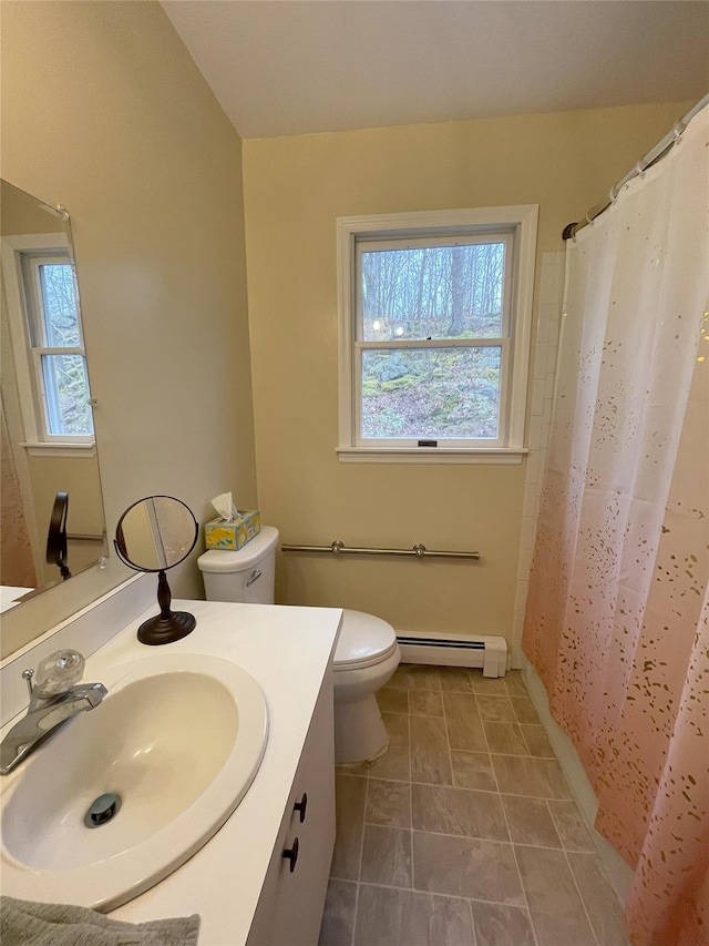 full bath featuring vanity, toilet, a healthy amount of sunlight, and a baseboard radiator