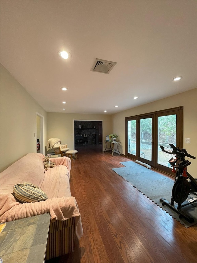 bedroom with recessed lighting, visible vents, wood finished floors, and access to outside