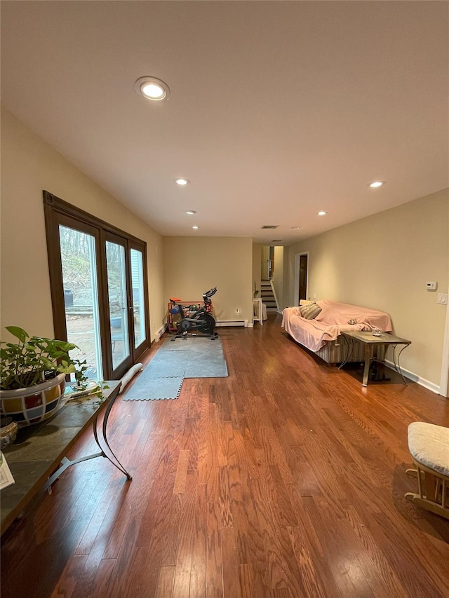 interior space featuring recessed lighting, wood finished floors, and baseboards