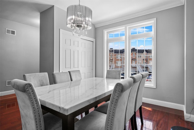 dining area with baseboards, visible vents, a chandelier, and dark wood-style flooring