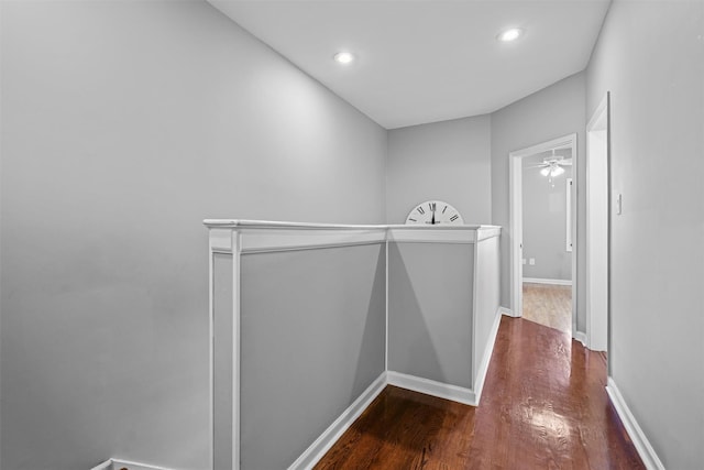 hall featuring recessed lighting, baseboards, and wood finished floors