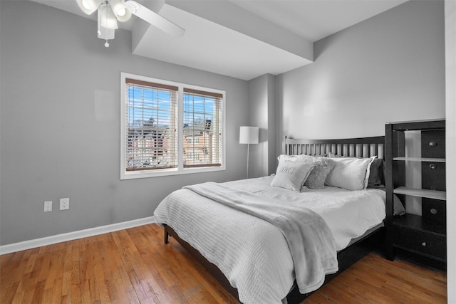 bedroom with wood-type flooring, baseboards, and ceiling fan