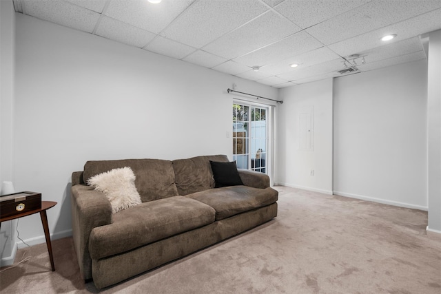 living area with carpet flooring, a drop ceiling, and baseboards