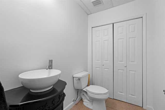 bathroom with tile patterned flooring, a closet, visible vents, and toilet