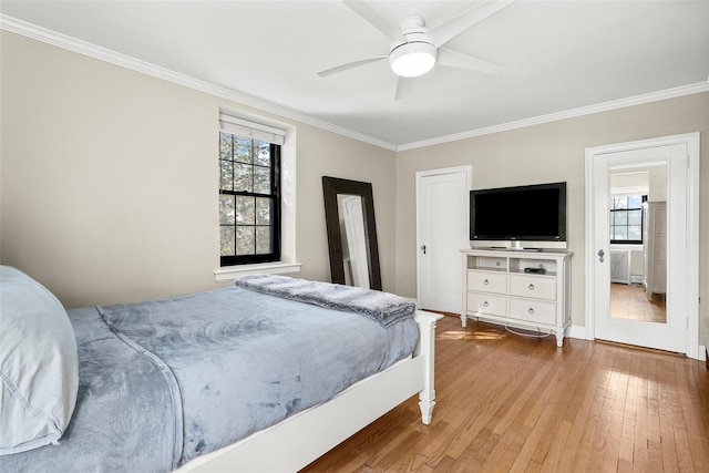 bedroom featuring ceiling fan, wood finished floors, and crown molding