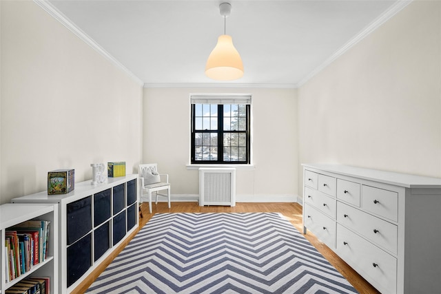 unfurnished room featuring crown molding, radiator heating unit, baseboards, and light wood-style floors