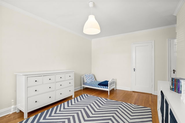 bedroom featuring crown molding, baseboards, and dark wood-style flooring