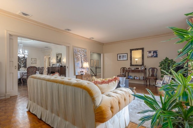 living area featuring an inviting chandelier, ornamental molding, and visible vents