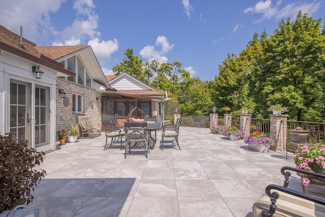 view of patio featuring fence, french doors, and outdoor dining space