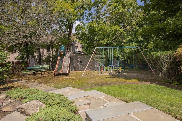 communal playground with fence and a lawn