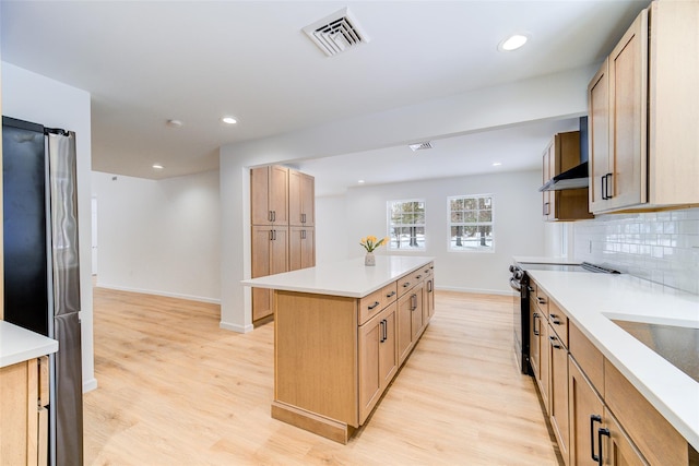 kitchen featuring light countertops, visible vents, decorative backsplash, electric range oven, and under cabinet range hood