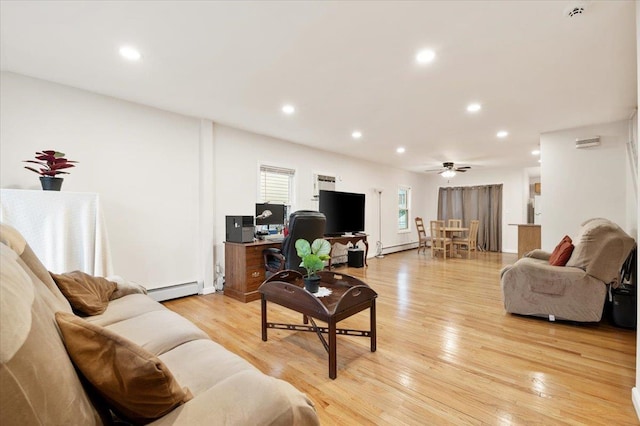 living area featuring a baseboard heating unit, light wood-style flooring, recessed lighting, and ceiling fan