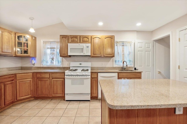 kitchen featuring a wealth of natural light, white appliances, a sink, and glass insert cabinets