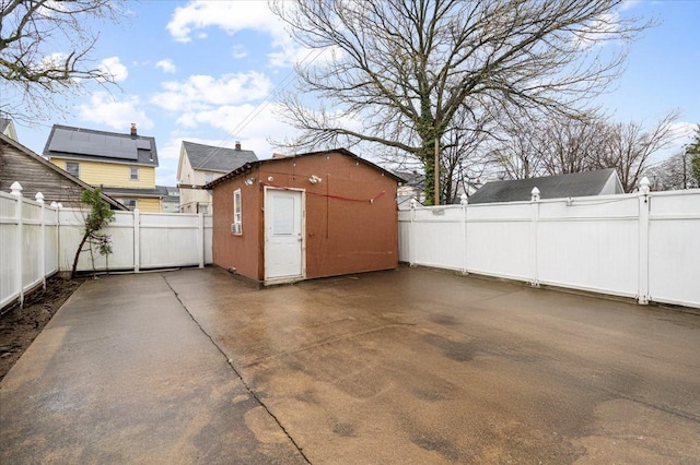exterior space with a fenced backyard and an outbuilding