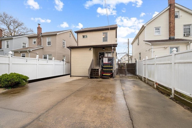back of property featuring fence and covered porch
