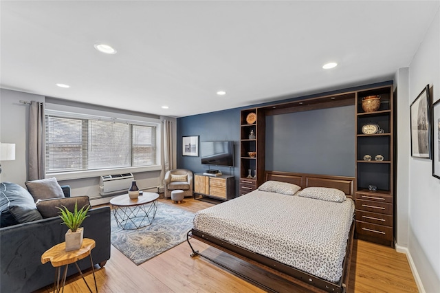 bedroom with light wood-type flooring, baseboards, and recessed lighting