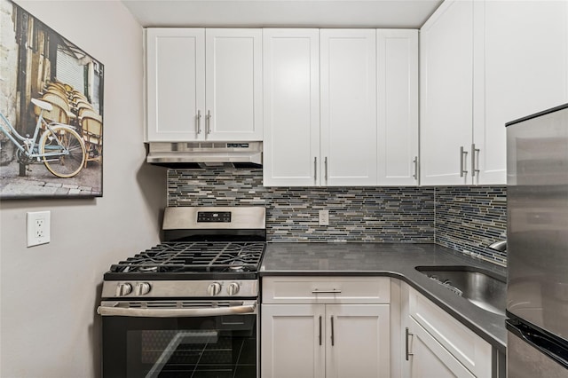 kitchen featuring stainless steel appliances, dark countertops, white cabinets, and under cabinet range hood