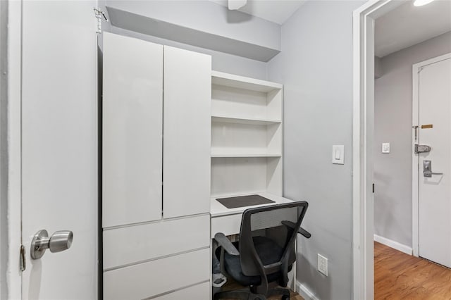 home office featuring light wood finished floors and baseboards