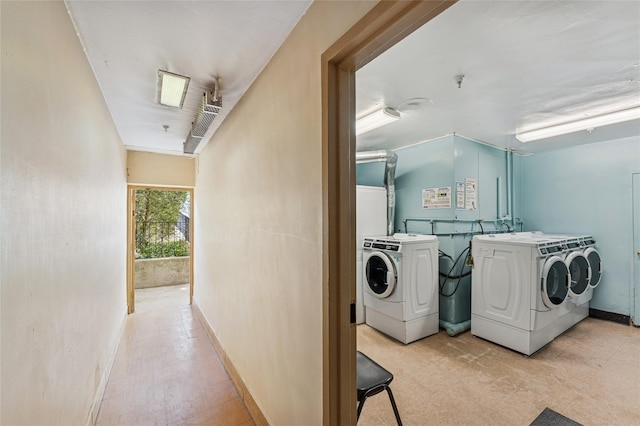 laundry room featuring laundry area, baseboards, and washing machine and clothes dryer