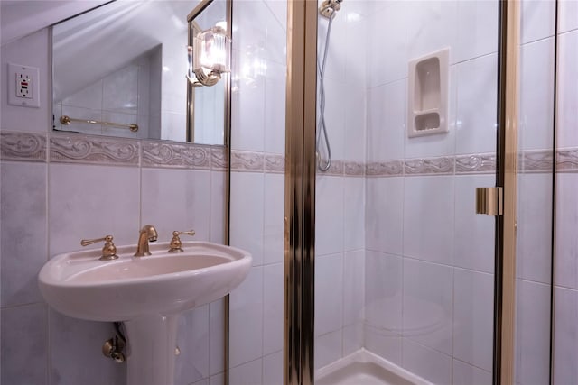 full bathroom with a shower stall and tile walls