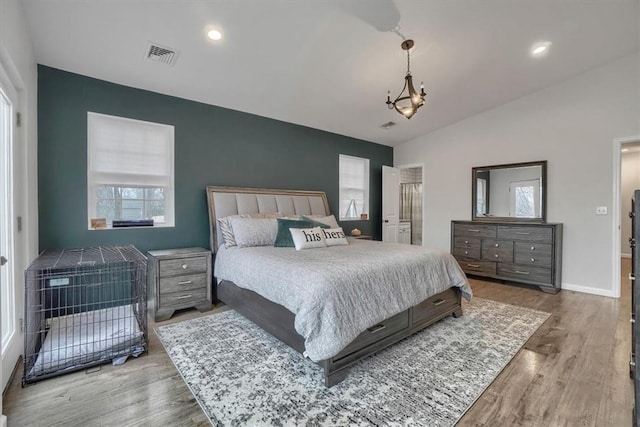 bedroom featuring lofted ceiling, recessed lighting, wood finished floors, visible vents, and baseboards