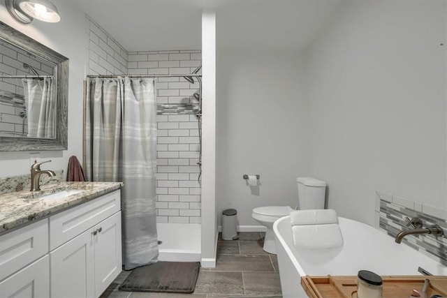 bathroom with toilet, a stall shower, and vanity