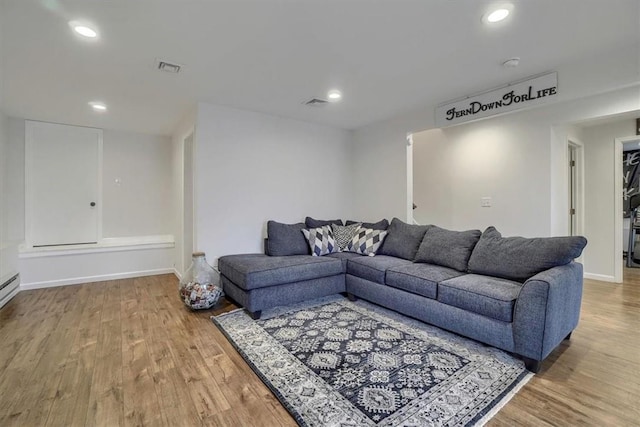 living area with recessed lighting, baseboards, and wood finished floors